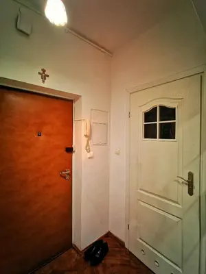 a hallway with a door and a cross on the wall at Krakow Centrum Gurgacza Apartments in Kraków