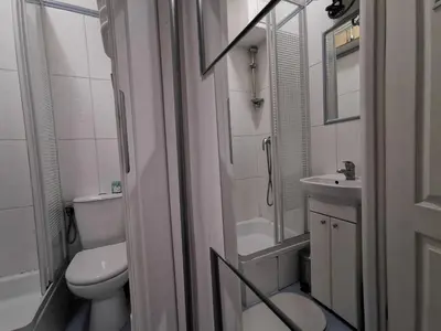a small bathroom with a toilet and a sink at Krakow Centrum Gurgacza Apartments in Kraków