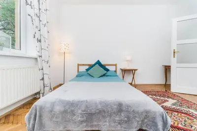 a bedroom with a bed and a window at Two separate bedrooms,10 min walk to the city center by Homeclick in Kraków