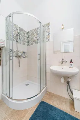 a bathroom with a shower and a sink at Two separate bedrooms,10 min walk to the city center by Homeclick in Kraków