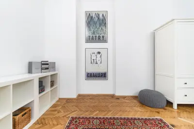 a living room with white walls and a rug at Two separate bedrooms,10 min walk to the city center by Homeclick in Kraków