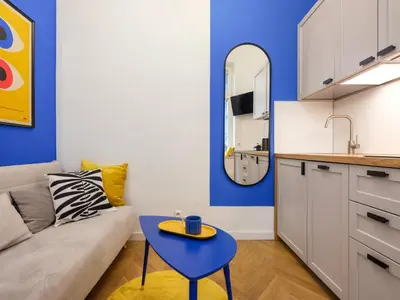 a living room with a couch and a table at MioMio Apartments in Kraków