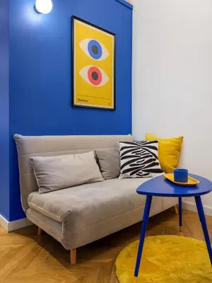 a living room with a couch and a table at MioMio Apartments in Kraków