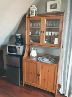 a kitchen with a microwave and a cabinet with a tea kettle at Apartament STUDIO i Apartament ZADOMEK Spytkowice koło ZATORA in Spytkowice