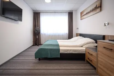 a hotel room with a bed and a window at Hut Pus Spółka Akcyjna in Kraków