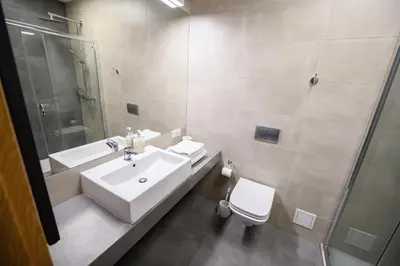 a bathroom with a sink and a shower and a toilet at Hut Pus Spółka Akcyjna in Kraków