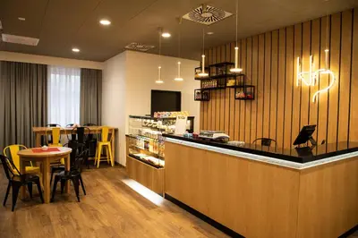 a restaurant with a counter and a table and chairs at Hut Pus Spółka Akcyjna in Kraków
