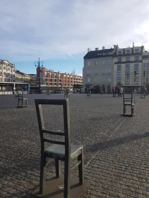 a chair sitting in the middle of a street at Apartamenty Za Winklem in Kraków