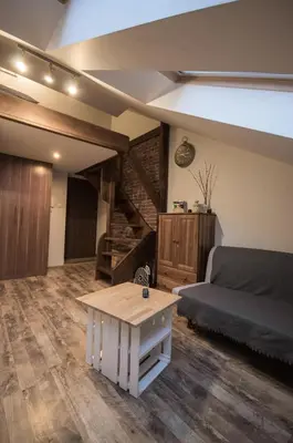 a living room with a couch and a coffee table at Apartamenty Za Winklem in Kraków
