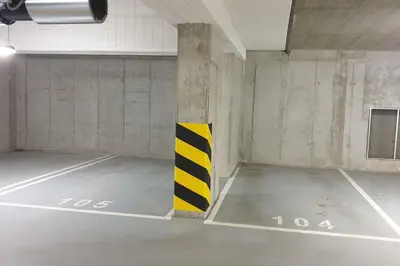 an empty parking garage with a yellow and black pole at Luksusowy apartament z tarasem in Kraków