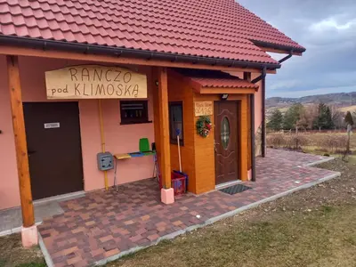 a small house with a sign on the side of it at Ranczo pod Klimoską in Rzyki