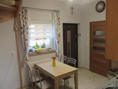 a table and chairs in a kitchen with a window at Ranczo pod Klimoską in Rzyki