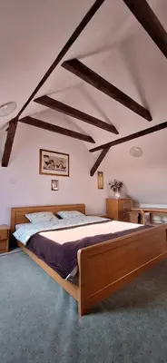 a bedroom with a large bed in a attic at Dom nad Wisłą in Czernichów