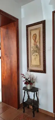 a room with a table and a picture on the wall at Dom nad Wisłą in Czernichów