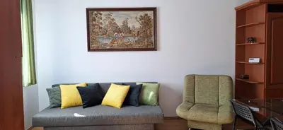 a living room with a couch and a chair at Dom nad Wisłą in Czernichów