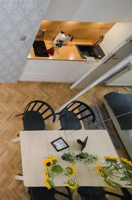 a room with a table and chairs with flowers on it at Cracovia Wawel Apartments in Kraków