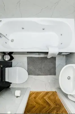 a white bathroom with a sink and a toilet at Cracovia Wawel Apartments in Kraków