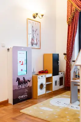 a living room with a tv and a box at Pokoje Gościnne Cheval in Kraków
