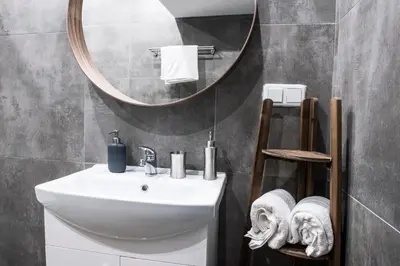 a bathroom with a sink and a mirror at Tomasza 20 Apartment 140m2 in Kraków