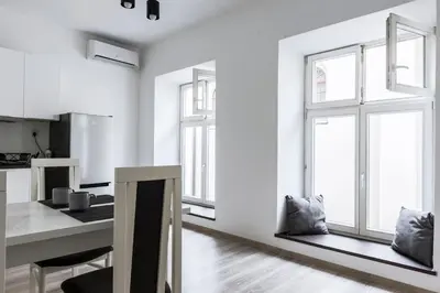 a kitchen with white walls and a large window at Tomasza 20 Apartment 140m2 in Kraków
