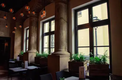 a room with tables and chairs and windows at Tomasza 20 Apartment 140m2 in Kraków