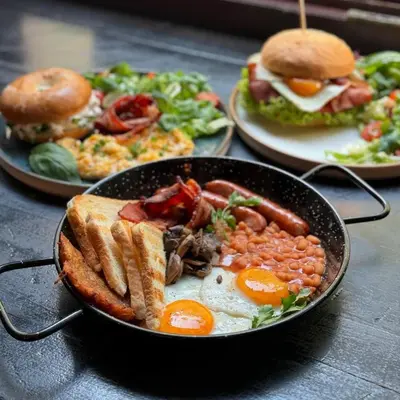 a pan filled with eggs and beans and a sandwich at Tomasza 20 Apartment 140m2 in Kraków