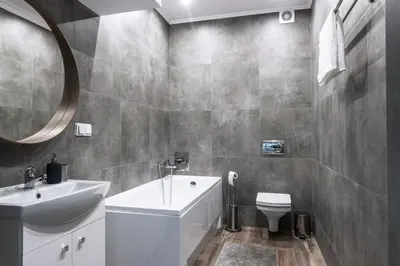 a bathroom with a sink and a toilet and a mirror at Tomasza 20 Apartment 140m2 in Kraków