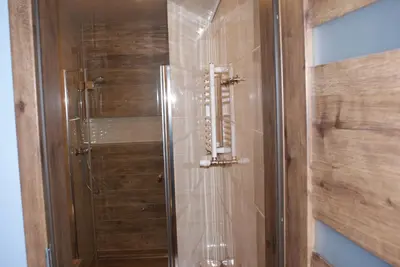 a shower with a glass door in a bathroom at Agrogosia in Czajowice