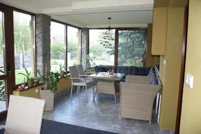 a living room with a couch and a table and chairs at Agrogosia in Czajowice
