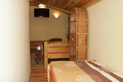 a room with a bed and a tv on a wall at Agrogosia in Czajowice