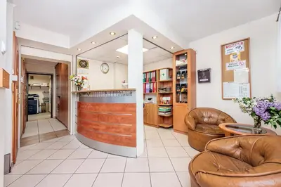 a barber shop with leather chairs and a counter at Dom Kolping in Kraków