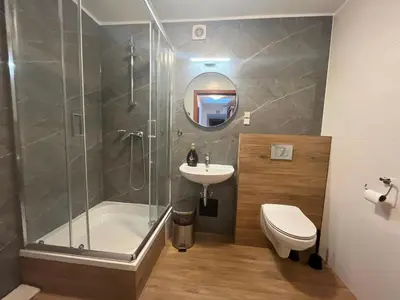 a bathroom with a shower and a sink and a toilet at Dom Kolping in Kraków