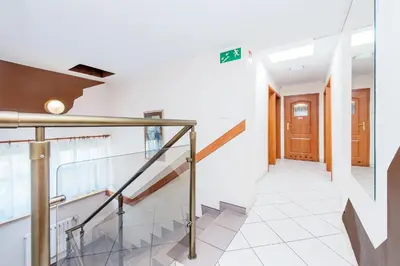 a hallway with a staircase in a house at Dom Kolping in Kraków