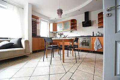 a kitchen with a table and chairs and a couch at Mhost Bronowice in Kraków