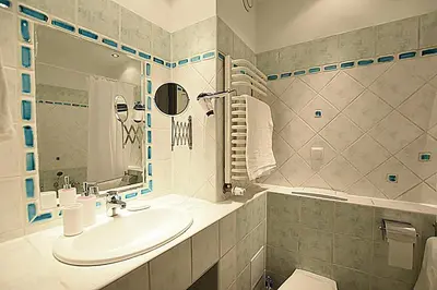 a bathroom with a sink and a toilet at Mhost Bronowice in Kraków