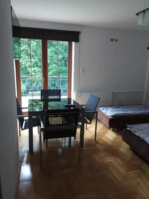 a living room with a table and chairs and a bed at Apartament Przy Skale u Anny in Sąspów