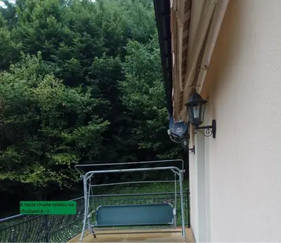 a balcony with a bench on the side of a building at Apartament Przy Skale u Anny in Sąspów