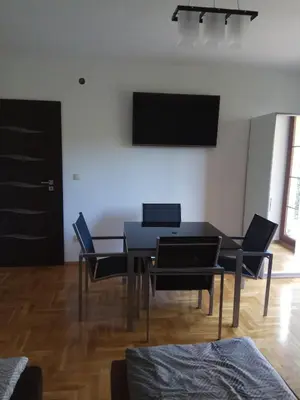 a dining room with a black table and chairs at Apartament Przy Skale u Anny in Sąspów