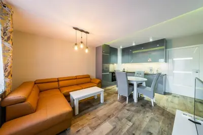 a living room with a couch and a table at Apartament Rakowicka 14 Deluxe Old Town WAWELOFTS in Kraków