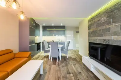 a living room with a couch and a table at Apartament Rakowicka 14 Deluxe Old Town WAWELOFTS in Kraków