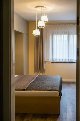 a bedroom with a bed and a window at Apartament Rakowicka 14 Deluxe Old Town WAWELOFTS in Kraków