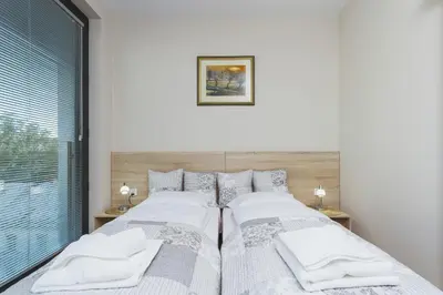 two beds sitting next to each other in a bedroom at Apartments Kraków Rajska 3 by Noclegi Renters in Kraków