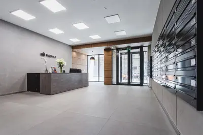 a lobby with a reception desk in a building at Apartments Kraków Rajska 3 by Noclegi Renters in Kraków
