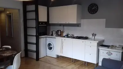 a kitchen with a sink and a washing machine at Własny Pokój in Kraków