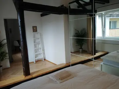 a bedroom with a bed and a glass wall at Własny Pokój in Kraków