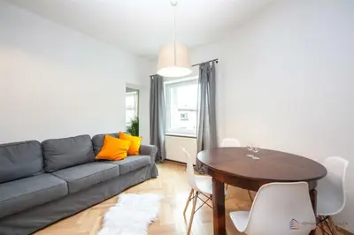 a living room with a couch and a table at Własny Pokój in Kraków