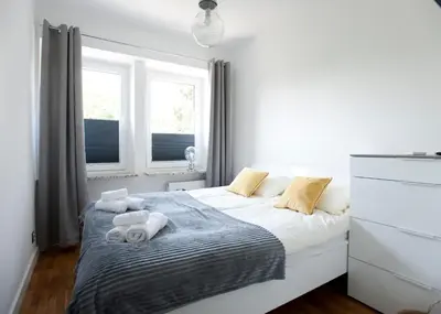 a bedroom with a bed with towels on it at Apartament Daszyńskiego in Kraków