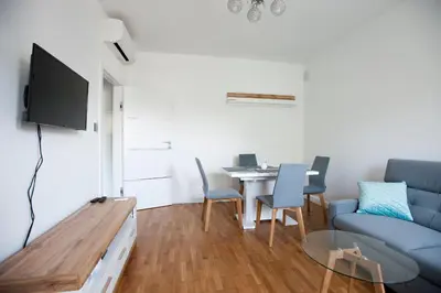 a living room with a couch and a table with chairs at Apartament Daszyńskiego in Kraków