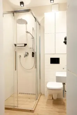 a bathroom with a shower with a toilet and a sink at Apartament Daszyńskiego in Kraków