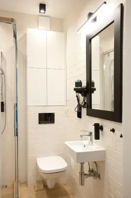 a bathroom with a sink and a toilet and a mirror at Apartament Daszyńskiego in Kraków
